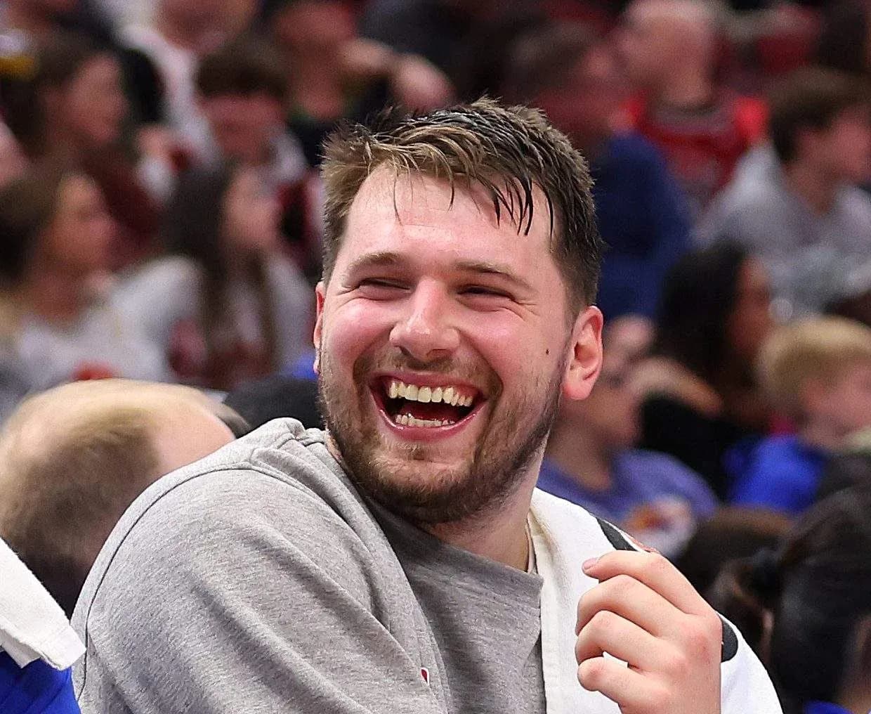 Player laughing on bench during basketball game