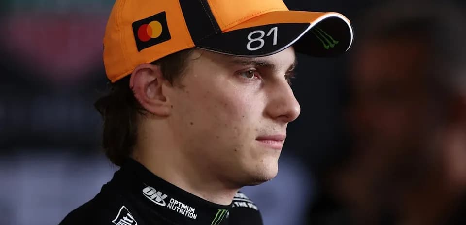 Racing driver wearing an orange cap with logo