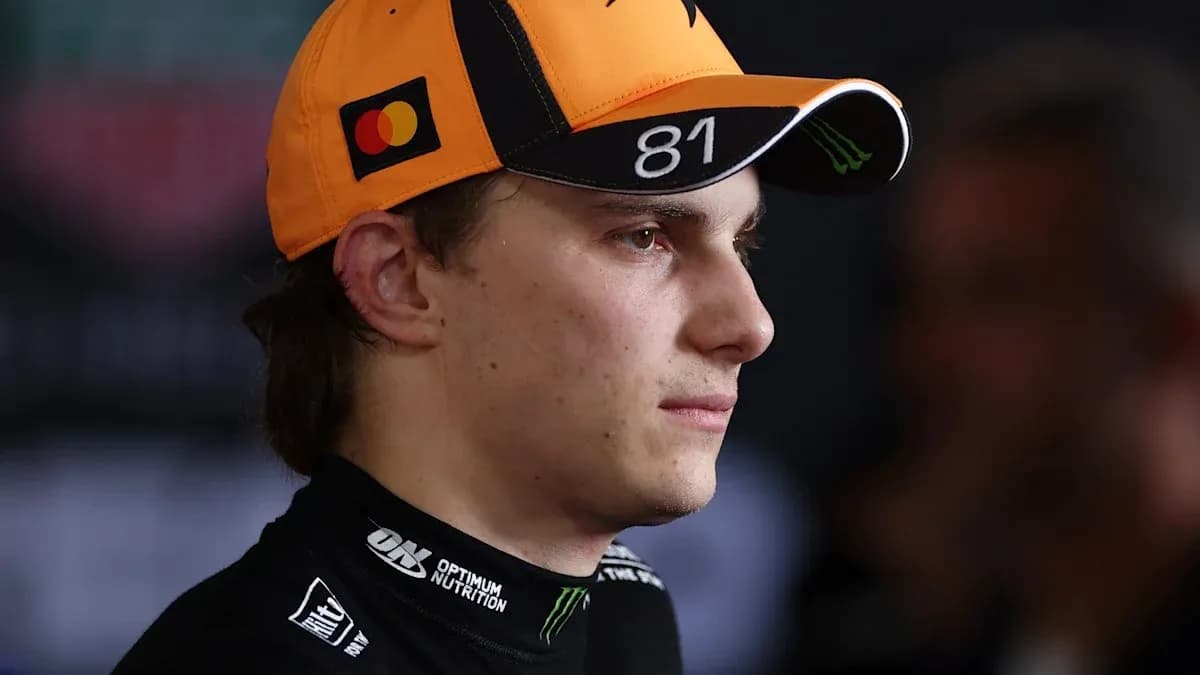 Racing driver wearing an orange cap with logo