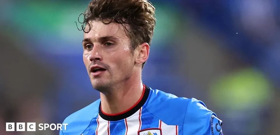 Player wearing Huddersfield Town kit during match