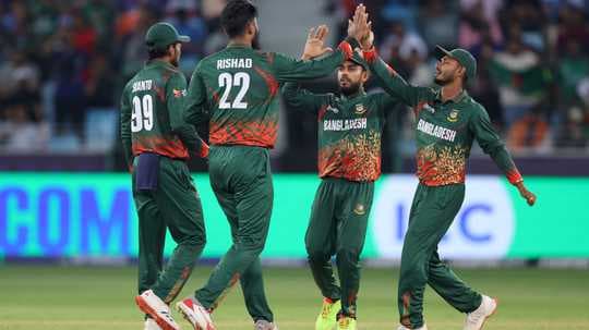 Bangladesh cricket team celebrating a wicket on field