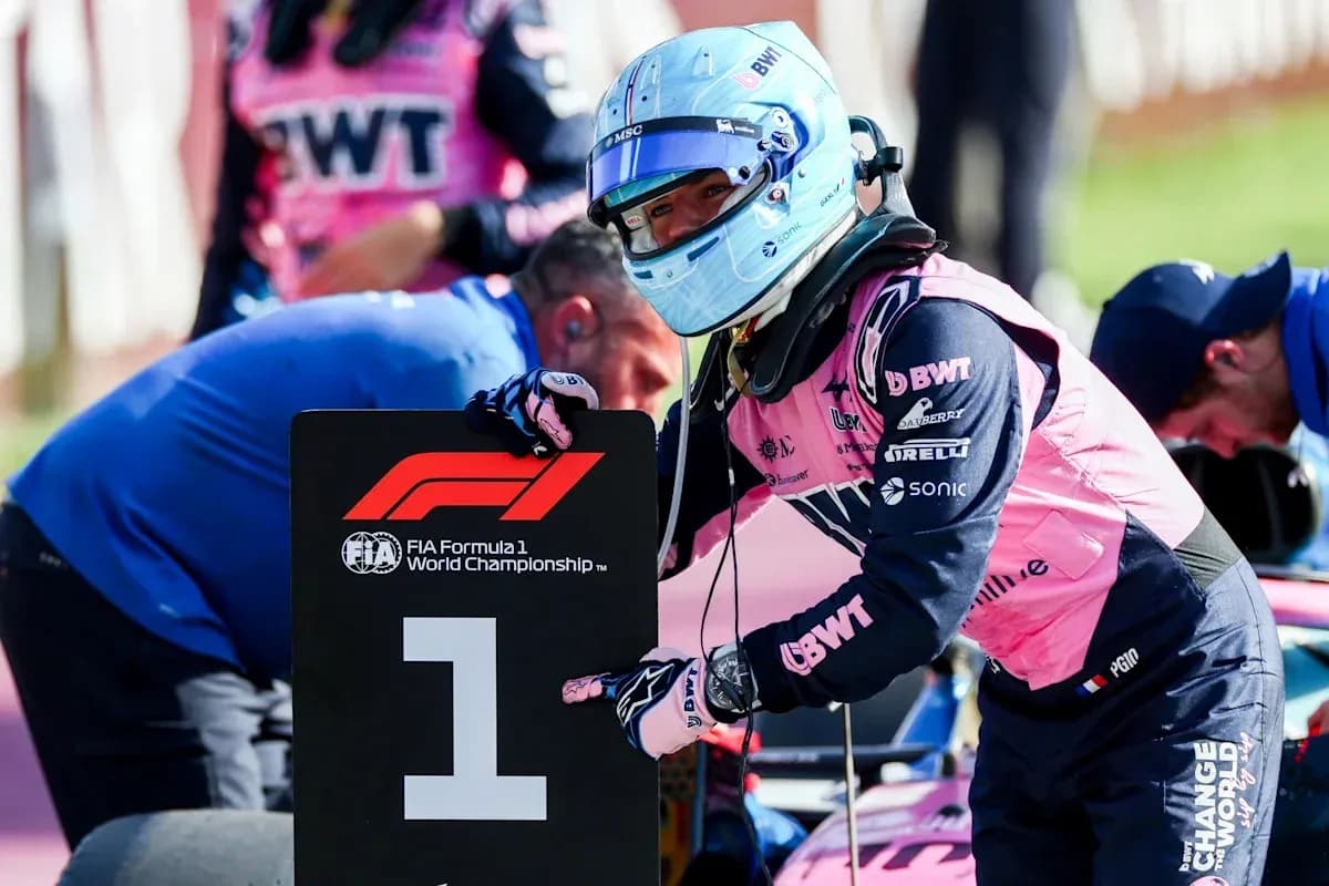 Driver holding '1' sign during Formula 1 event