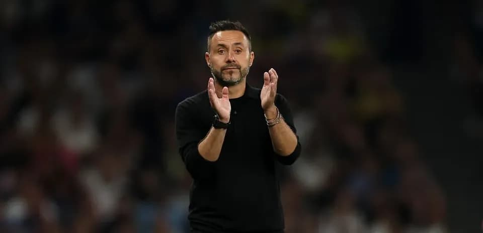Coach applauding from the sidelines during match