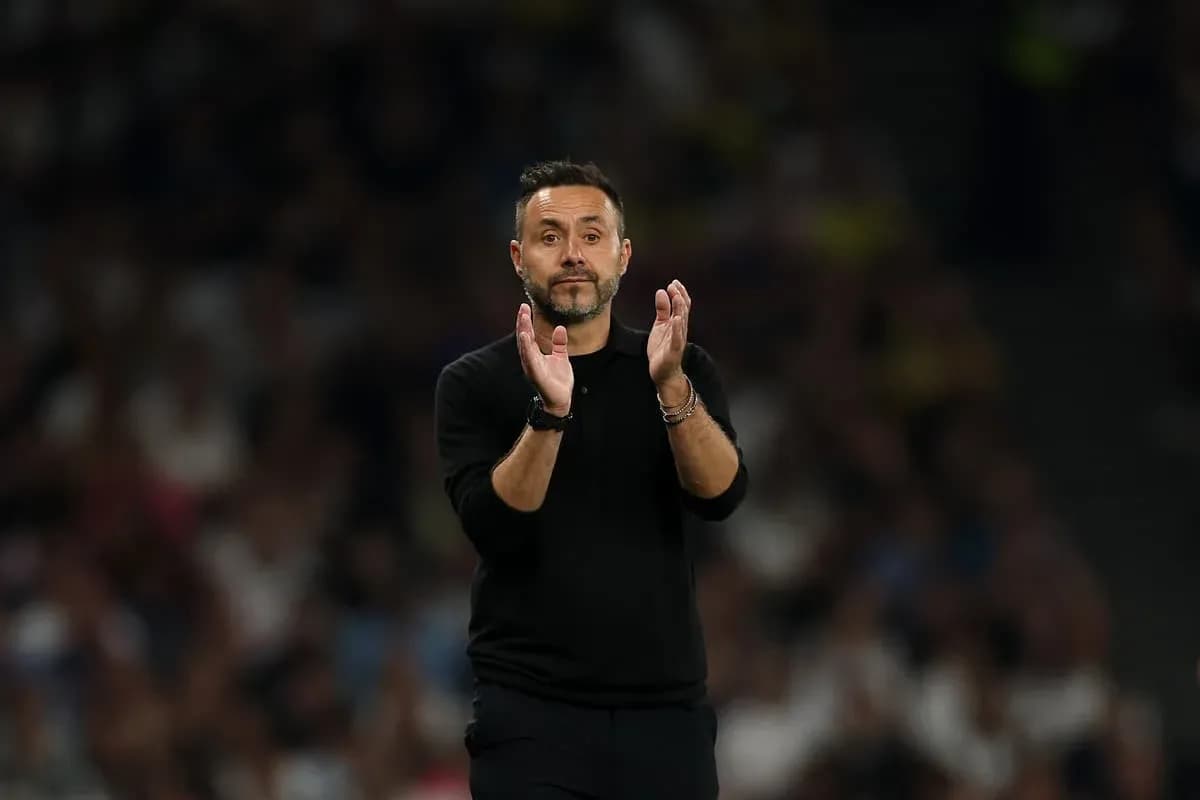 Coach applauding from the sidelines during match