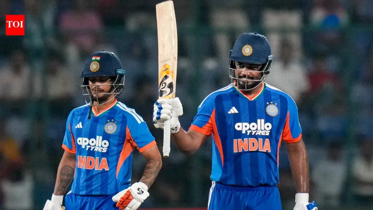 Two Indian cricketers celebrating a partnership on field