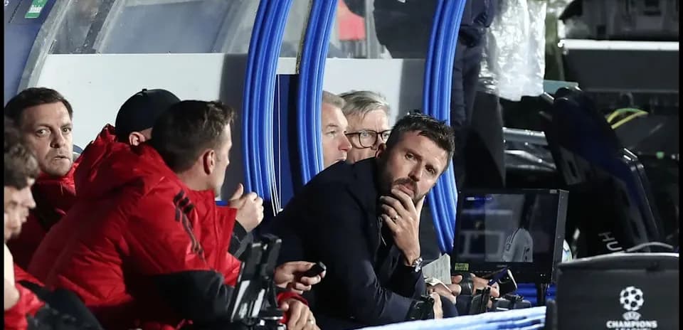 Coaching staff observing the match from the bench