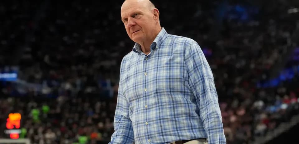 Man in checkered shirt walking on basketball court