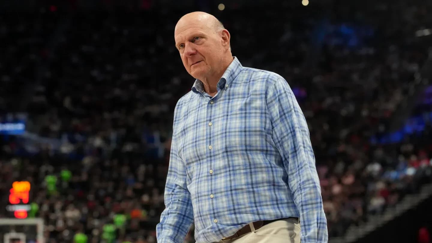 Man in checkered shirt walking on basketball court