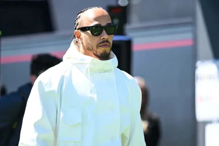 Driver wearing sunglasses and white jacket walking