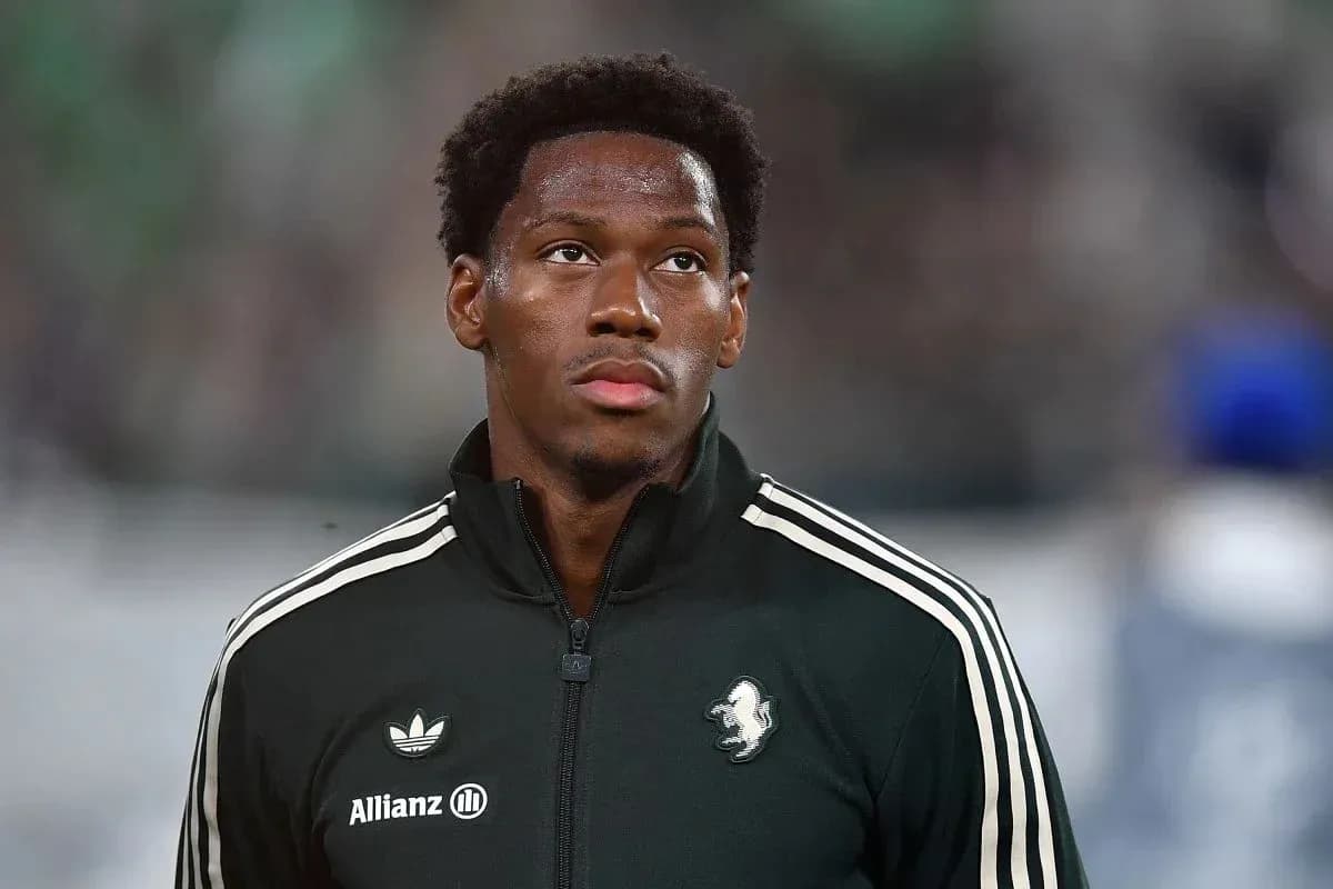 Player in black warm-up jacket on field