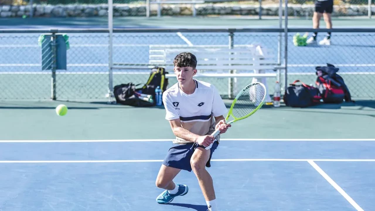 Player preparing to hit a tennis ball on court