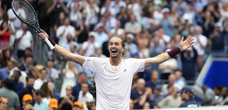 Player celebrating victory with arms raised in crowd