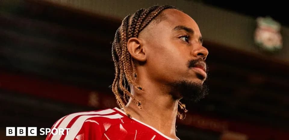 Player in red jersey looking off camera