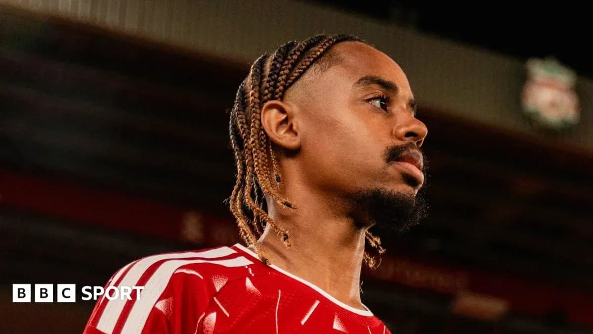 Player in red jersey looking off camera