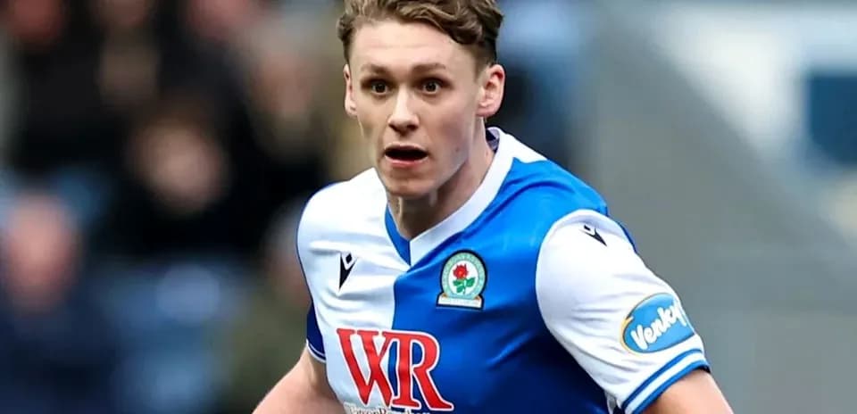 Player in Blackburn Rovers kit running on pitch