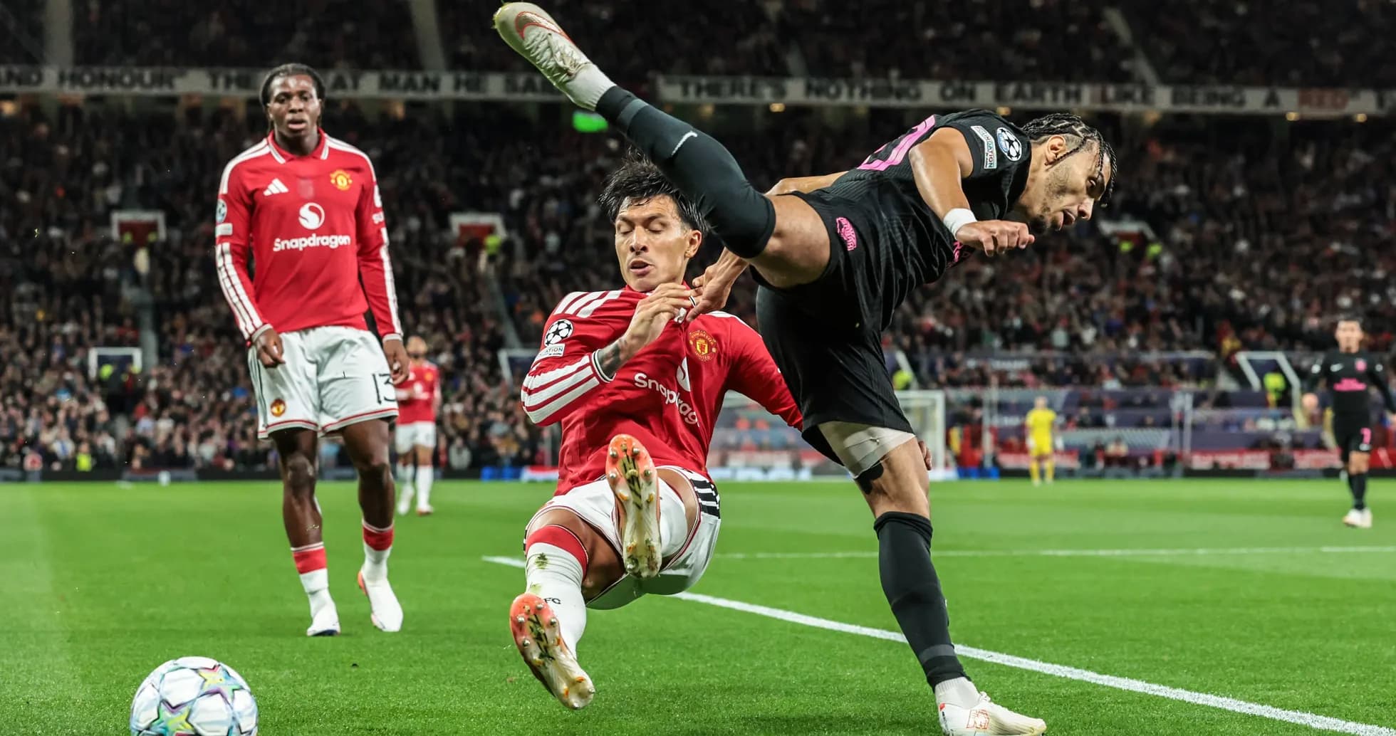 Player fouling opponent during match at Old Trafford