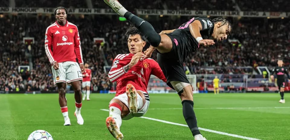 Player fouling opponent during match at Old Trafford
