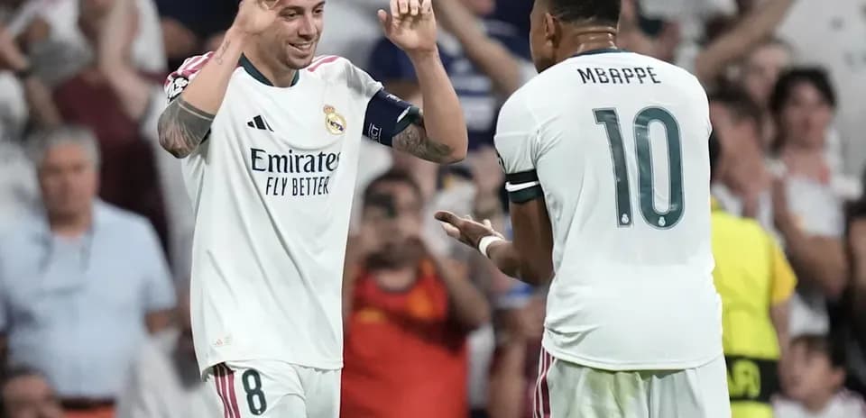 Two Real Madrid players celebrating a goal together