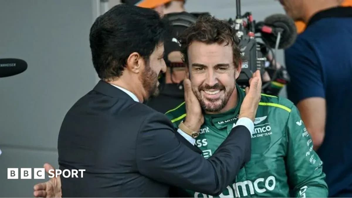 Two men interacting in a motorsport paddock