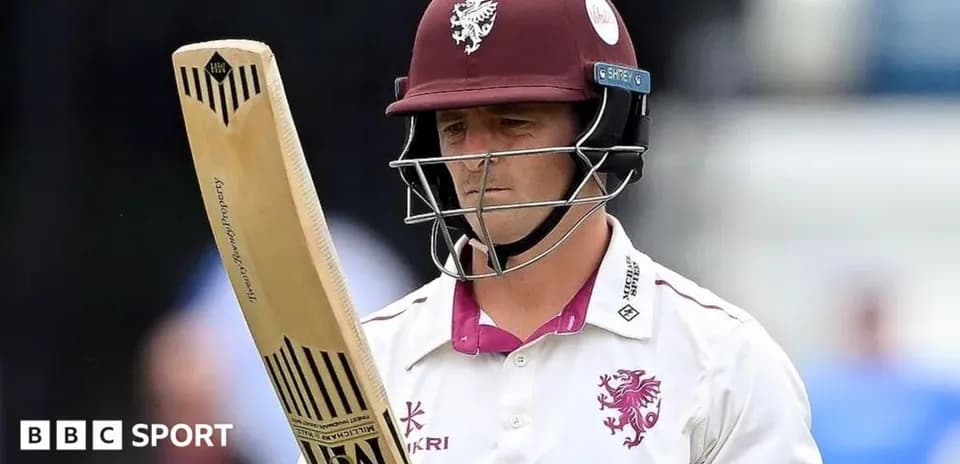 Cricketer from Somerset holding bat on field