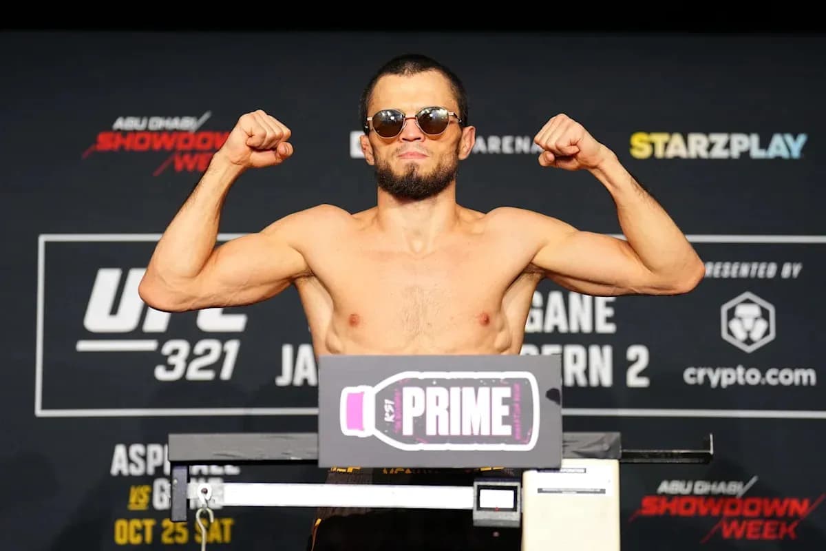 Fighter flexing muscles at weigh-in for UFC 321
