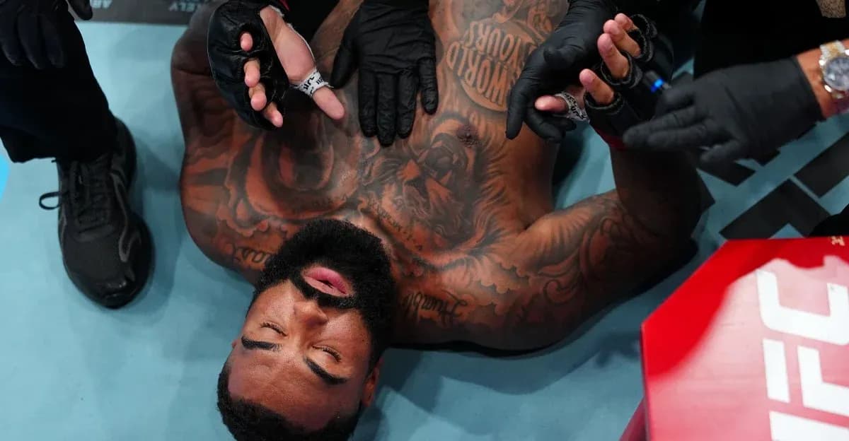 Fighter receiving medical attention on the mat
