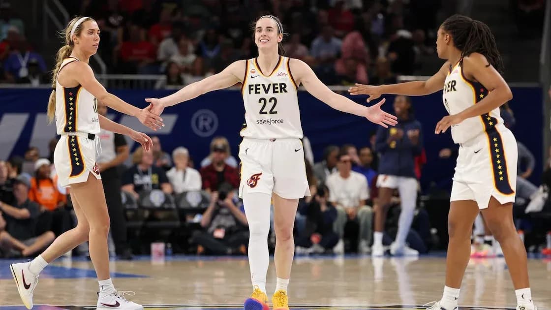 Three players celebrating during a basketball game