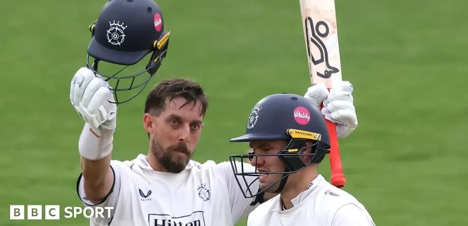 Two cricketers celebrating after scoring runs