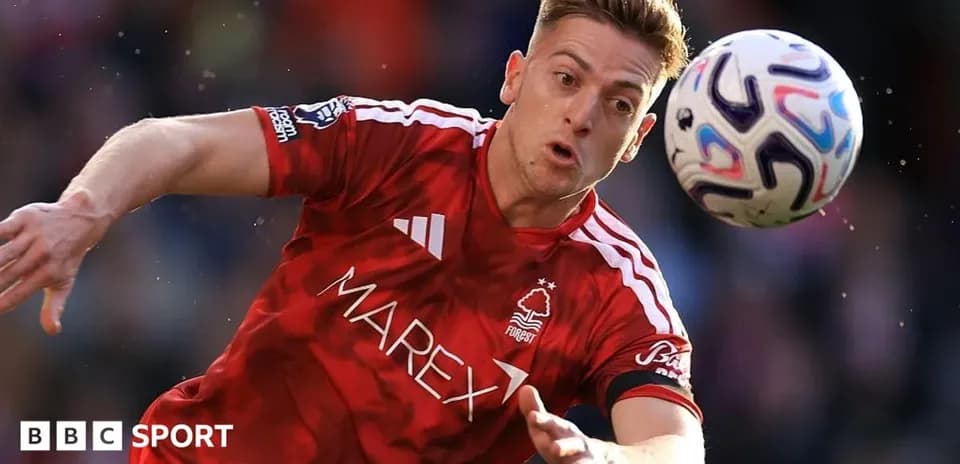 Player in red jersey attempting to control a soccer ball