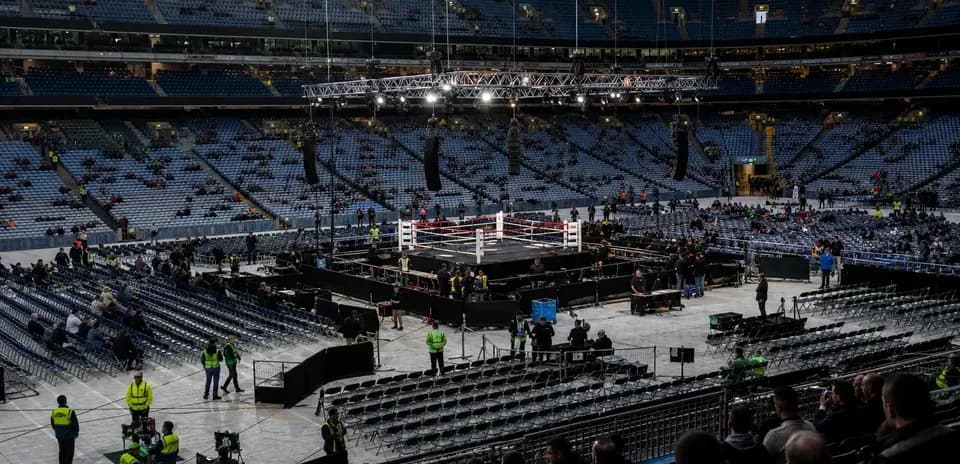 Empty arena with boxing ring and audience seating