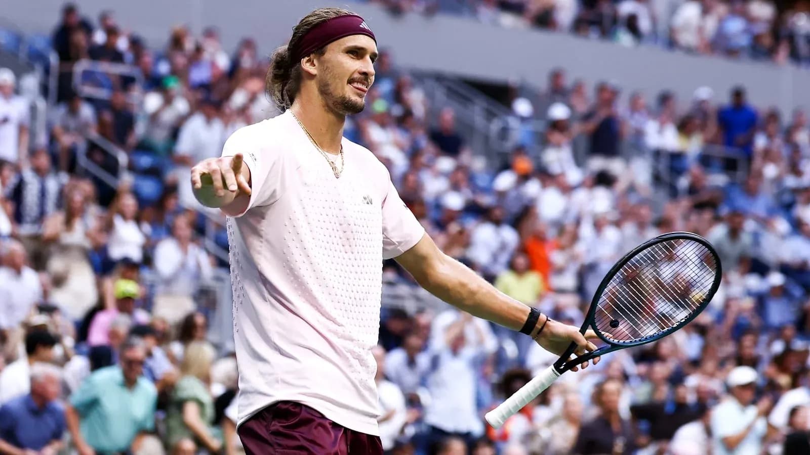 Tennis player gesturing to crowd during match