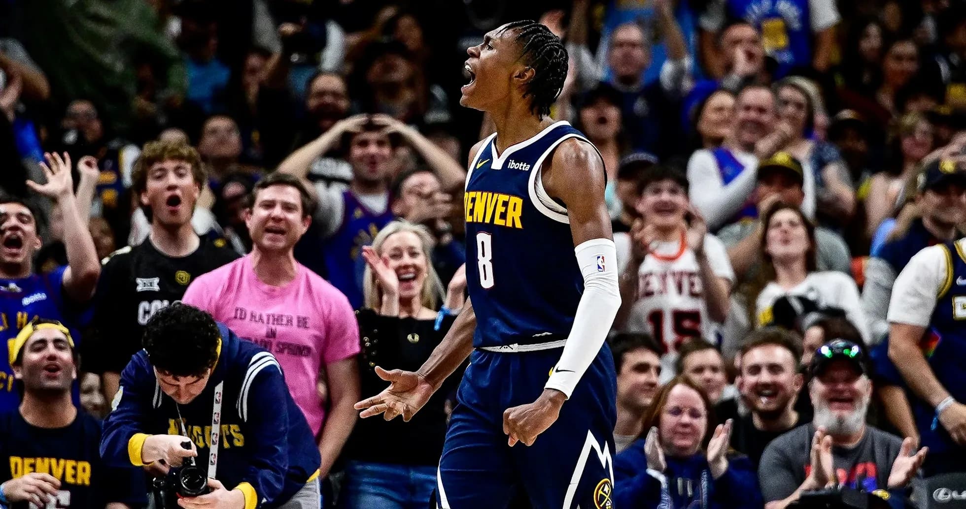 Player celebrating with fans during a basketball game