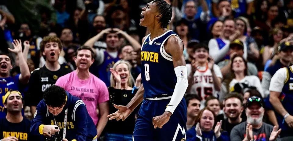 Player celebrating with fans during a basketball game