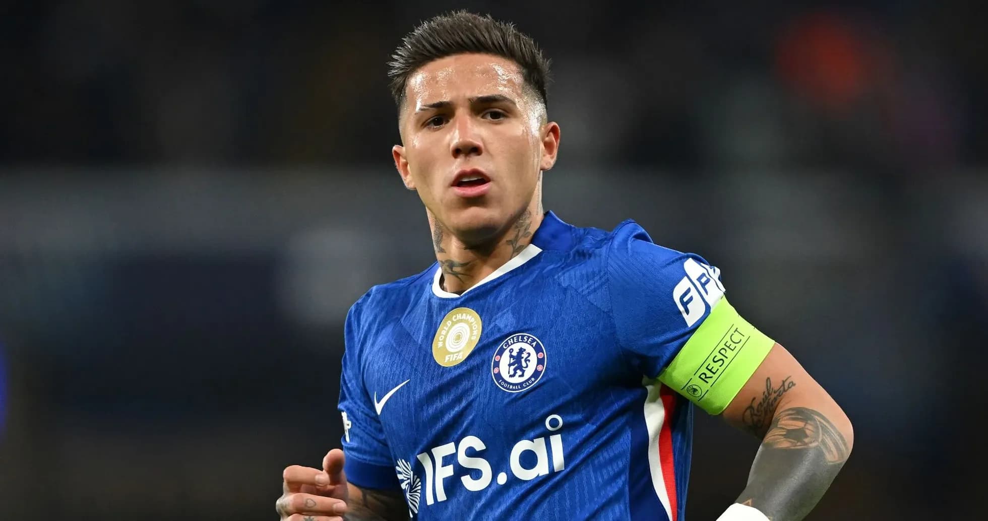 Player in blue jersey with captain's armband on field