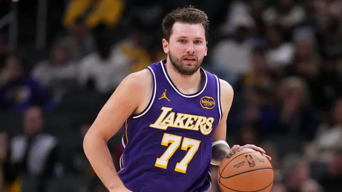 Player dribbling basketball during game in Lakers uniform
