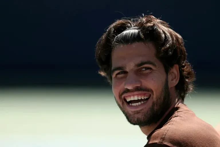 Smiling male tennis player during practice session