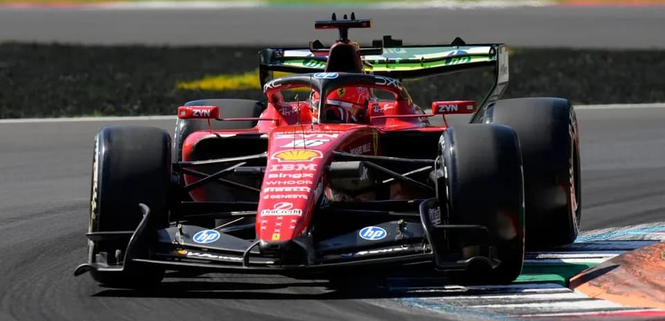 Ferrari car navigating a corner on racetrack