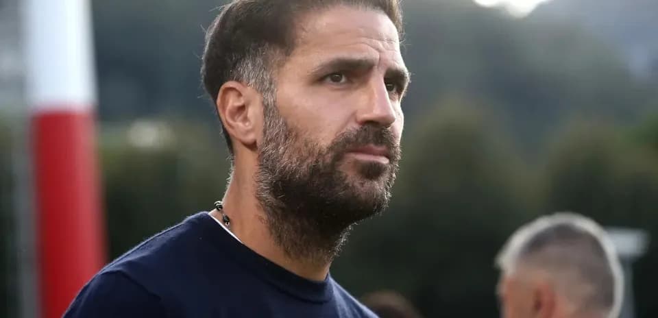 Man with beard observing football training session