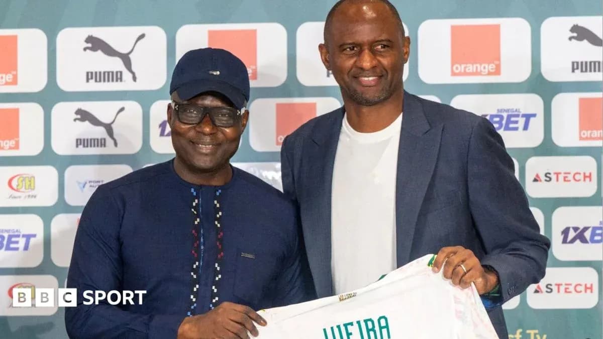Two men posing with a football jersey at event