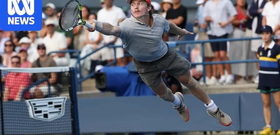 Player diving to hit a tennis ball during match