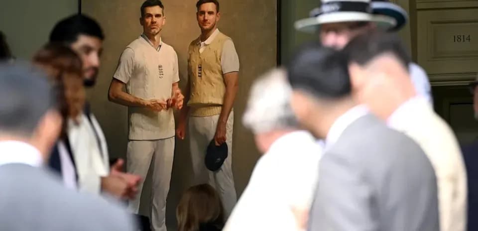 Crowd gathered around painting of two cricketers