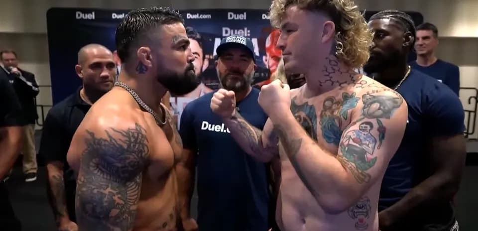 Two fighters facing off at weigh-in event