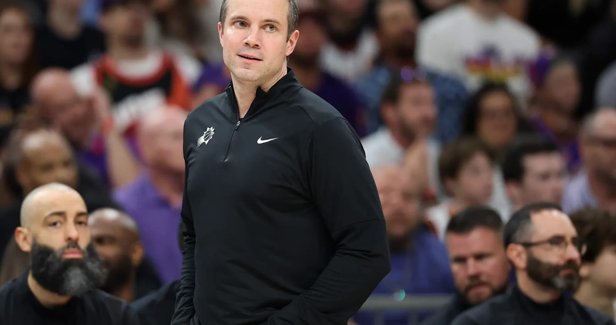 Coach observing game from the sidelines during match