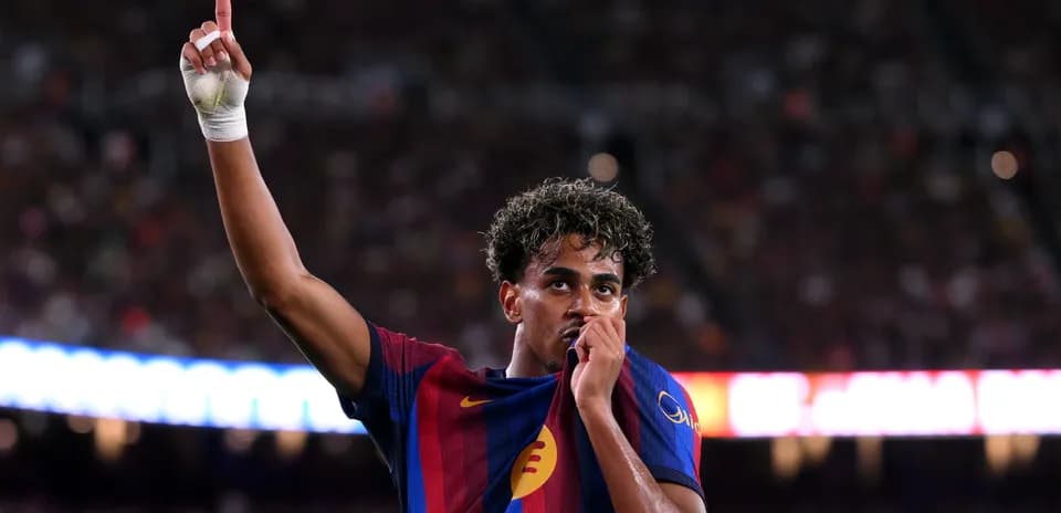 Player celebrating and holding shirt after scoring