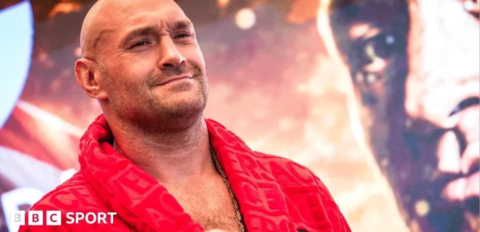 Boxer in red robe posing at event