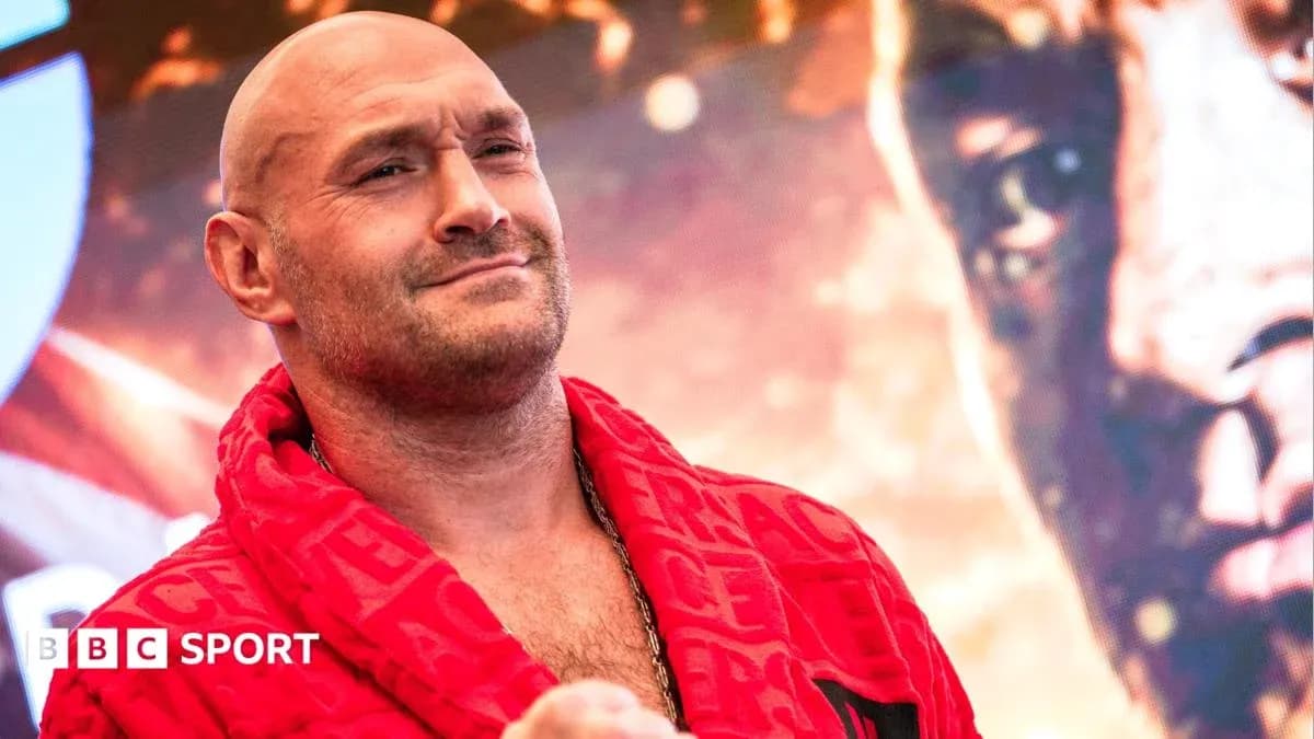 Boxer in red robe posing at event