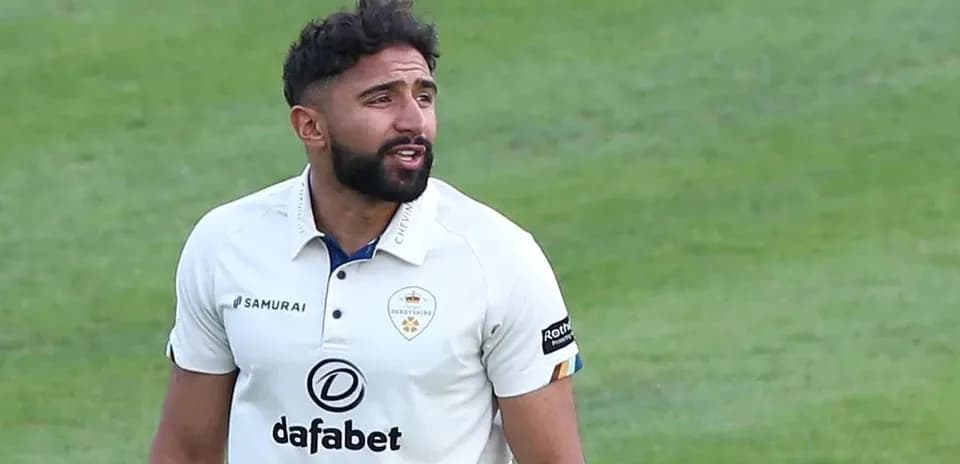 Cricketer wearing white kit on the field