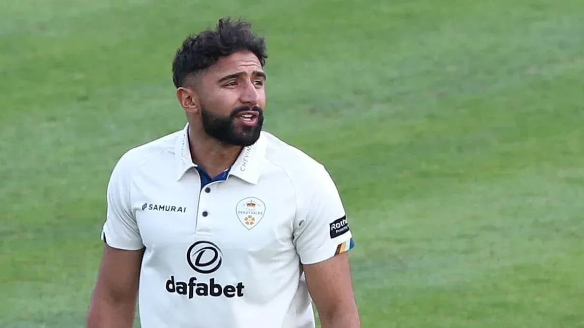 Cricketer wearing white kit on the field
