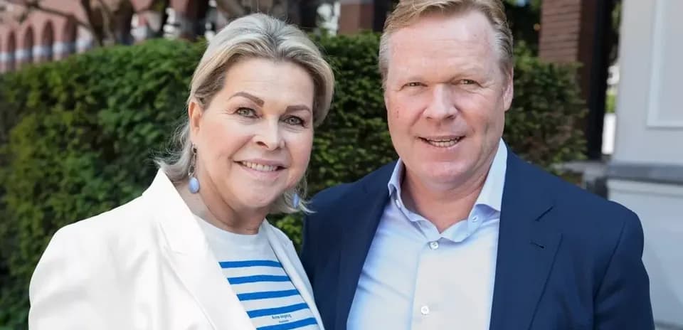 Man and woman posing outdoors, smiling at camera