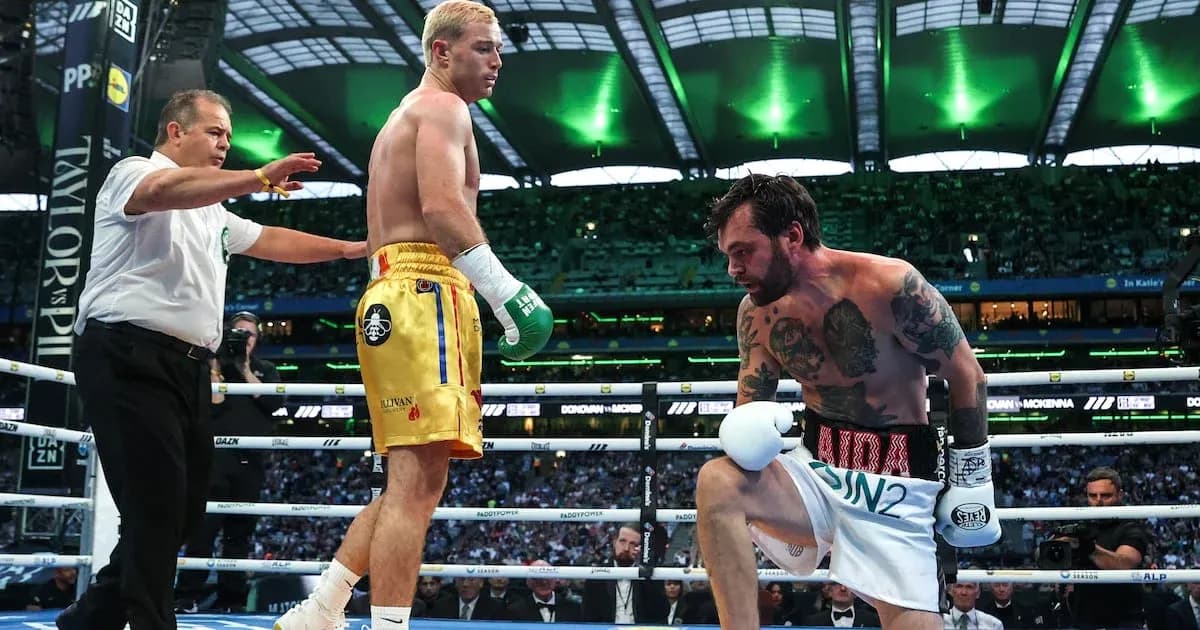 Boxers in ring during match with referee intervening